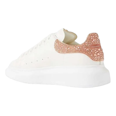 Alexander McQueen oversized casual sneakers in gold and rose with crystal accents, featuring a chunky sole design.