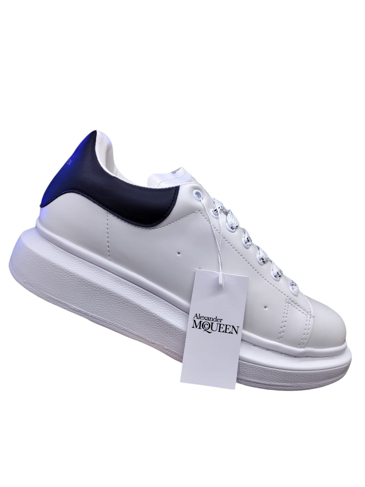 White and black Alexander McQueen-style casual sneakers with a sleek design and bold silhouette.