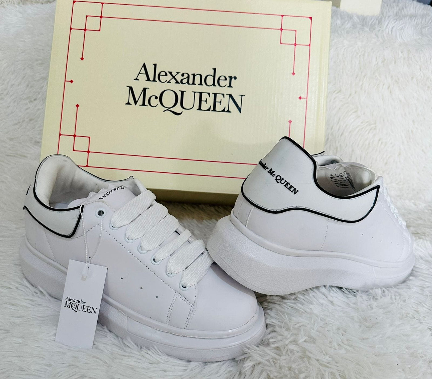 White casual sneakers inspired by Alexander McQueen, featuring a sleek design and high-quality materials.