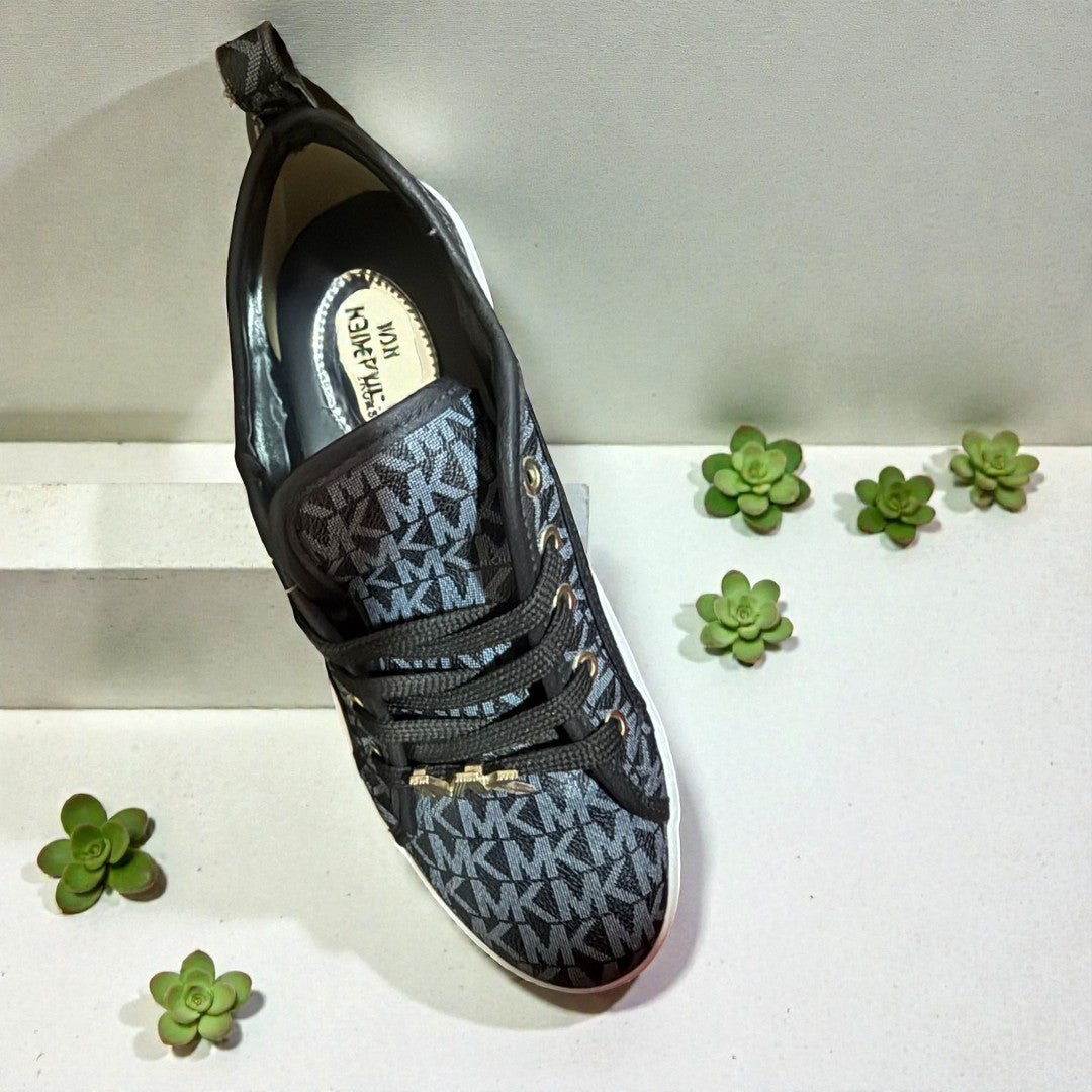 Unisex black and white casual sneakers by MK with a sleek design and comfortable fit.