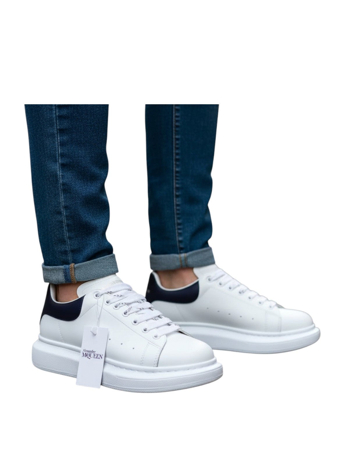 White and black Alexander McQueen-style sneakers with a trendy, rebellious design. Casual footwear for stylish looks.