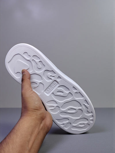 White casual sneakers inspired by Alexander McQueen, featuring a sleek design and high-quality materials.